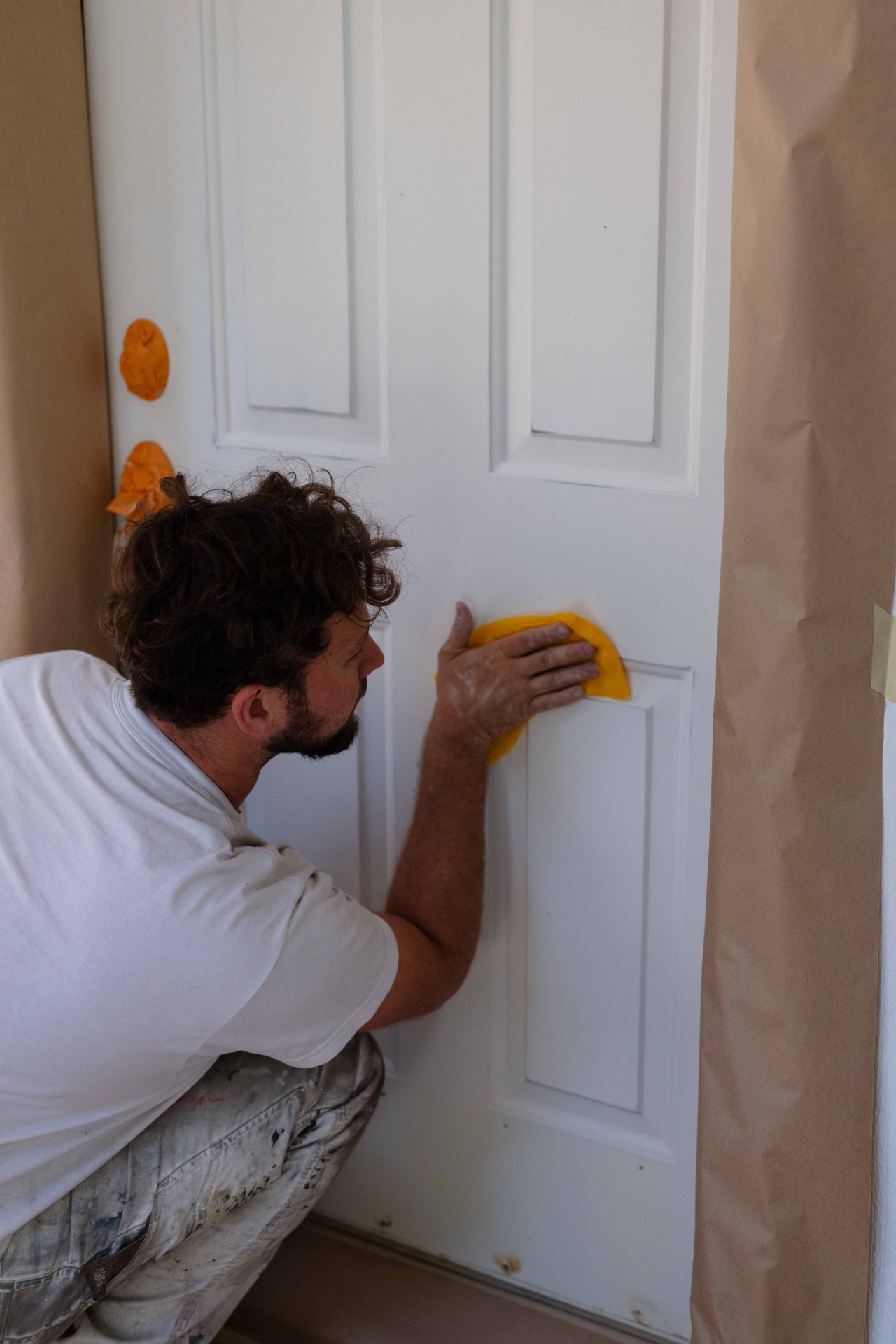 War Horse painter masking and prepping an interior door at a Hayden, ID home
