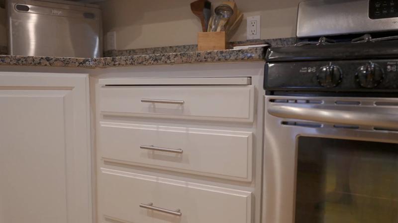 Close-up of freshly painted white cabinet drawers with brushed nickel hardware
