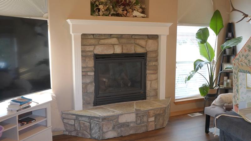 Fireplace mantel after refinishing with clean white painted trim