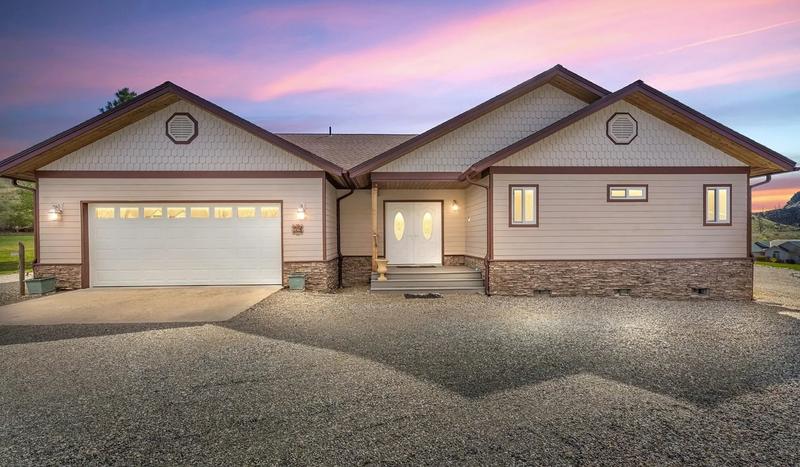 Front view of house with light beige tan siding and brown trim before exterior painting