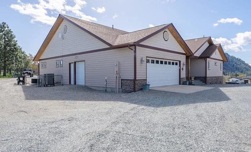 Side view of house with beige siding and garage before painting