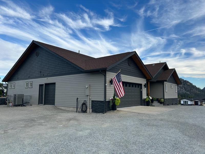 Side view of same house after painting in dark charcoal gray with American flag