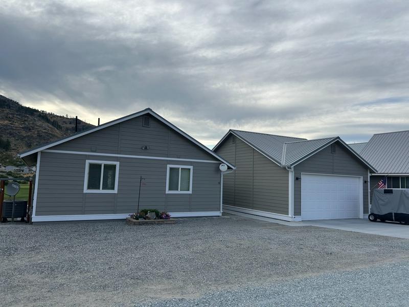 Front view of garage with gray siding before repainting