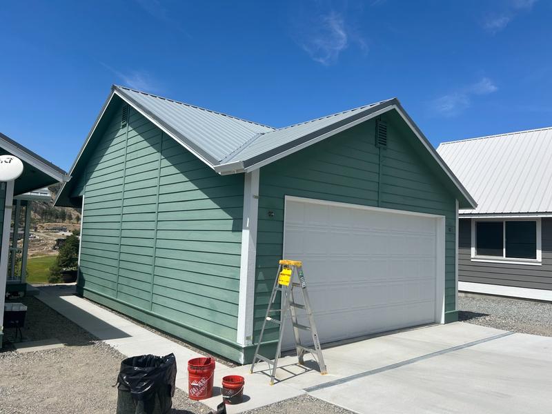 Garage after repainting in green teal with white garage door